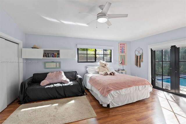 bedroom featuring hardwood / wood-style flooring, access to outside, ceiling fan, and french doors