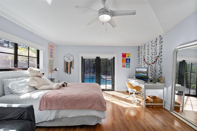 bedroom featuring ceiling fan, access to outside, light hardwood / wood-style floors, and french doors