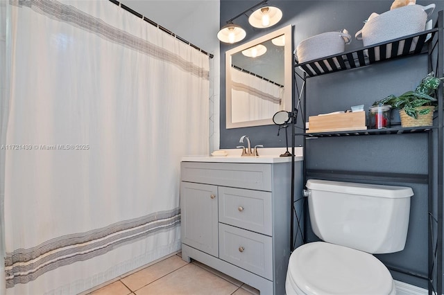 bathroom with tile patterned flooring, vanity, and toilet