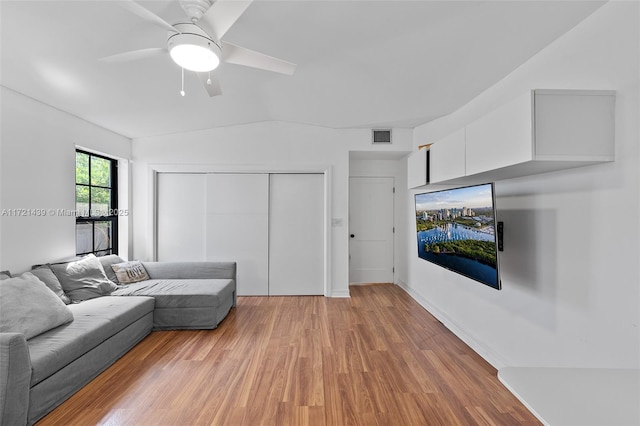 living room with light hardwood / wood-style flooring and ceiling fan