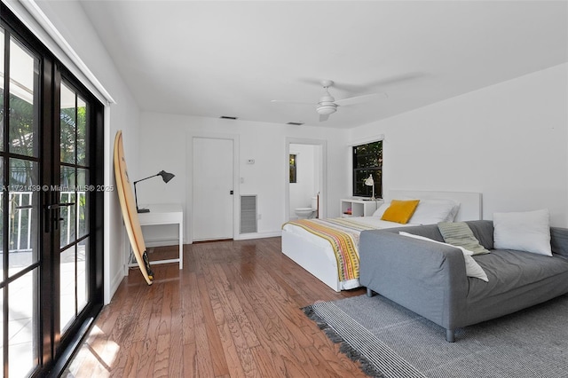 bedroom featuring ceiling fan, hardwood / wood-style floors, ensuite bath, and french doors