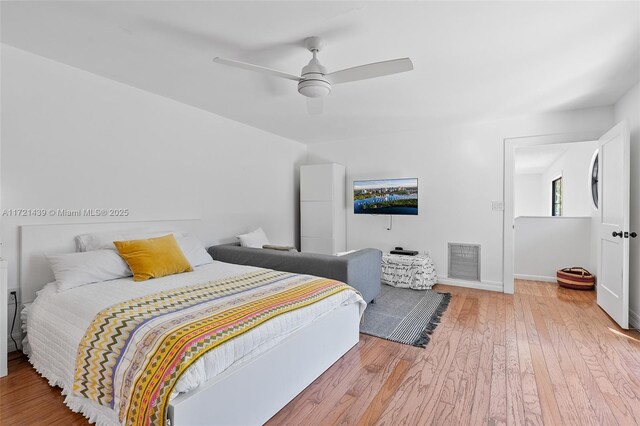 bedroom with light hardwood / wood-style flooring and ceiling fan