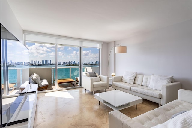 living room with expansive windows and a water view