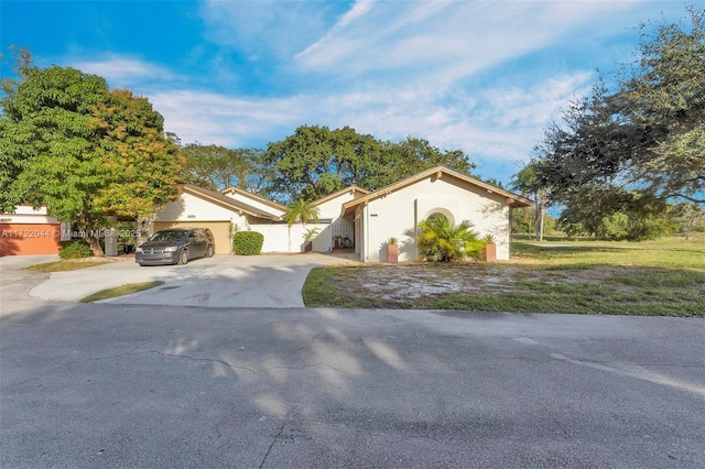 view of front facade with a front lawn and a garage