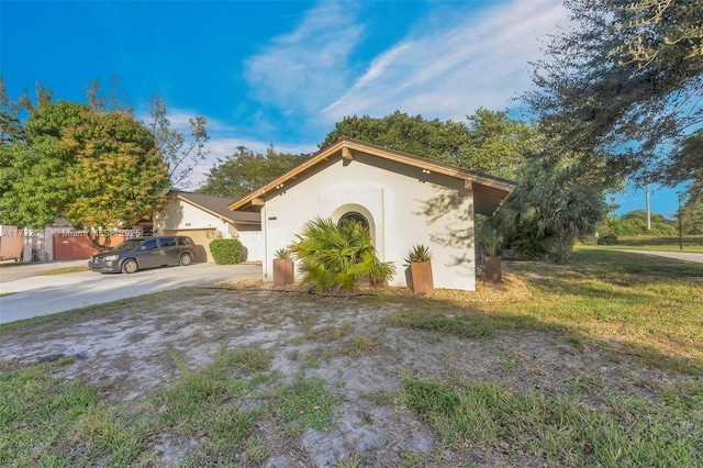 exterior space featuring a lawn and a garage