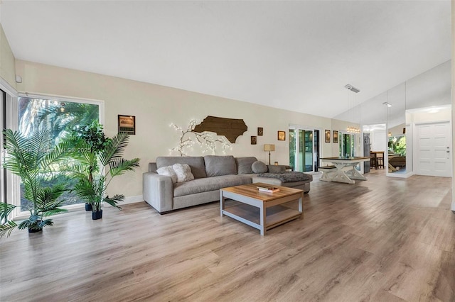 living room with lofted ceiling and light wood-type flooring