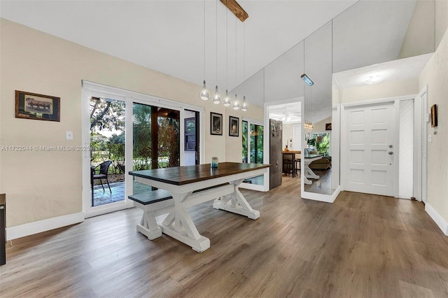 dining room with high vaulted ceiling, french doors, and hardwood / wood-style floors