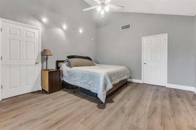 bedroom featuring vaulted ceiling, light wood-type flooring, and ceiling fan