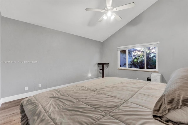 bedroom with hardwood / wood-style flooring, high vaulted ceiling, and ceiling fan