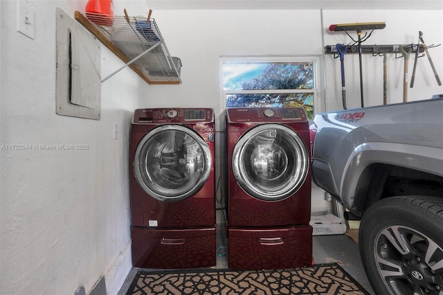 clothes washing area with washing machine and dryer