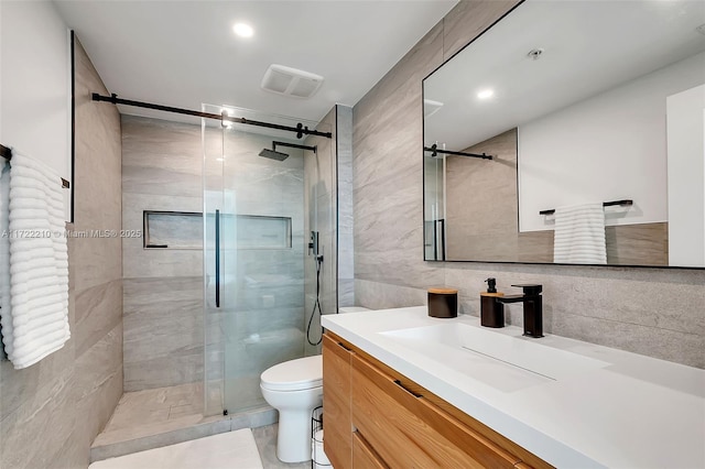 bathroom featuring tile walls, backsplash, vanity, walk in shower, and toilet