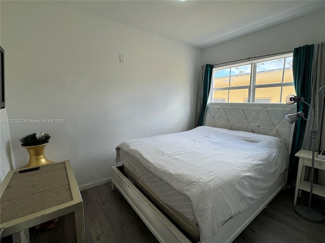 bedroom featuring dark wood-type flooring