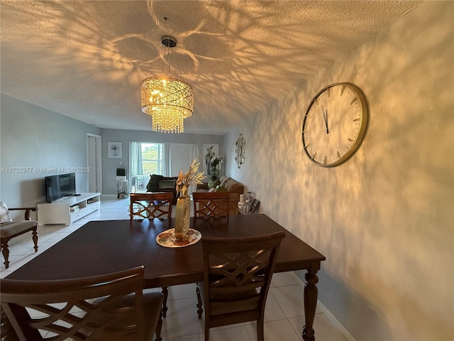 dining space with light tile patterned flooring, a textured ceiling, and an inviting chandelier