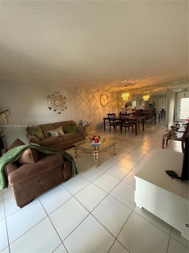 tiled living room featuring a textured ceiling