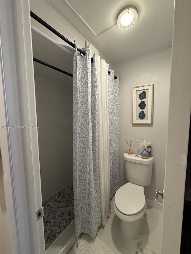 bathroom with toilet and walk in shower