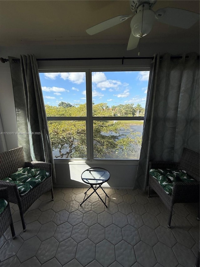 sunroom / solarium featuring a water view