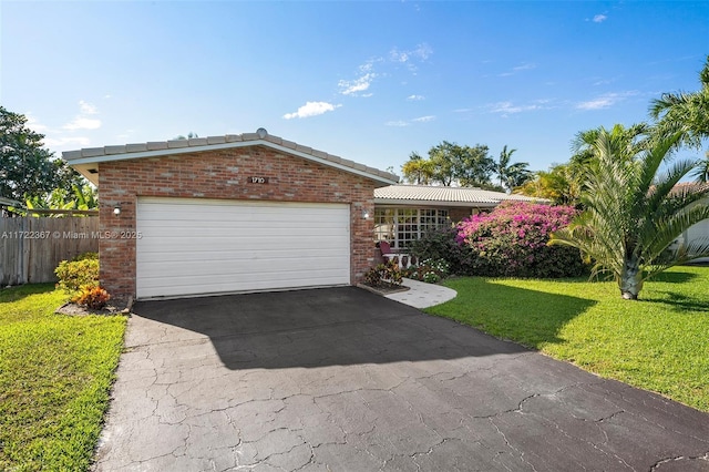 single story home featuring a garage and a front lawn