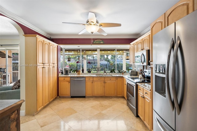 kitchen featuring ceiling fan, a healthy amount of sunlight, sink, and stainless steel appliances