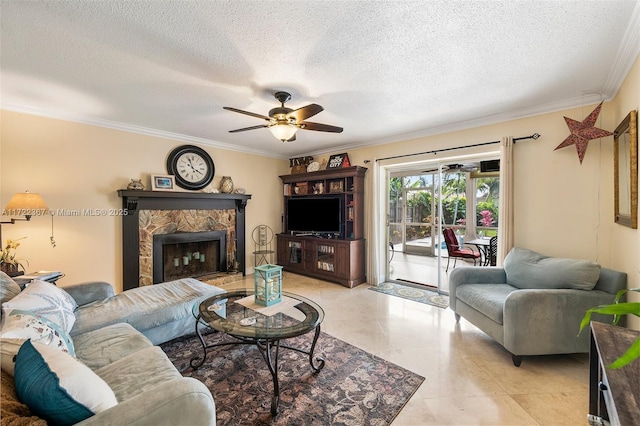 living room with ceiling fan, a fireplace, crown molding, and a textured ceiling