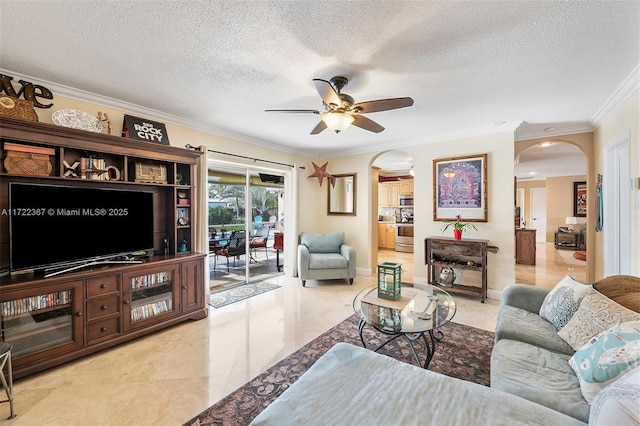 living room with ceiling fan, a textured ceiling, and ornamental molding