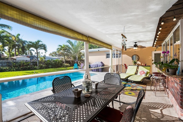 view of swimming pool featuring a patio area and a bar