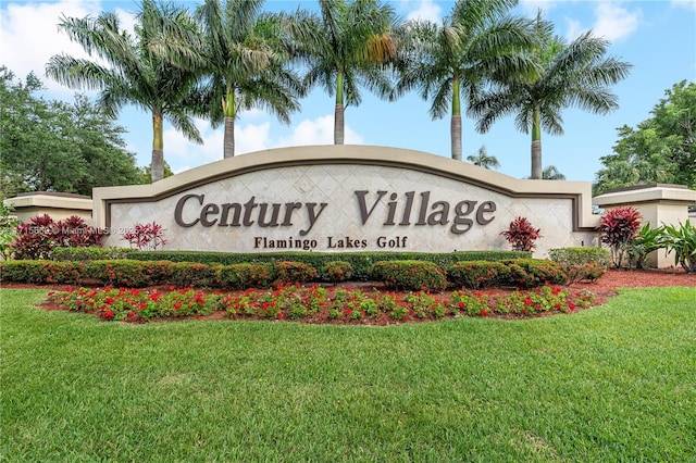 community / neighborhood sign featuring a yard