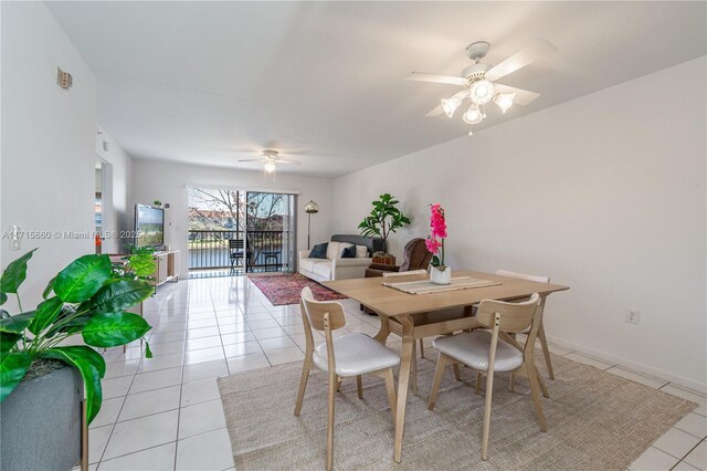 tiled dining area with ceiling fan