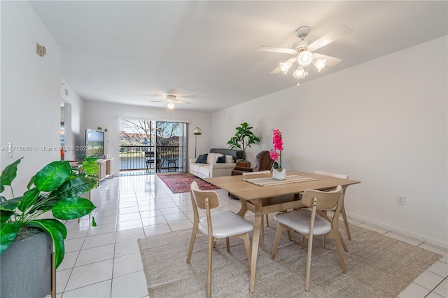 dining area with light tile patterned floors and ceiling fan