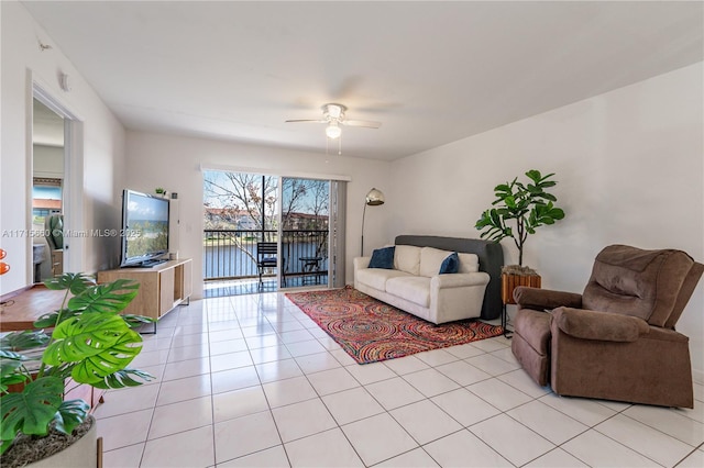 living room with light tile patterned floors and a ceiling fan