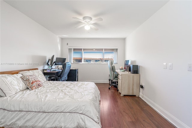 bedroom with a ceiling fan, dark wood-type flooring, and baseboards