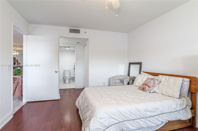 bedroom featuring ceiling fan, dark wood-type flooring, and connected bathroom