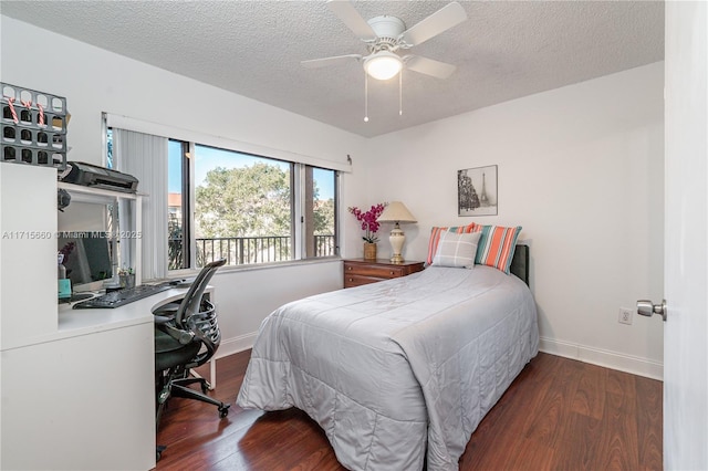 bedroom featuring wood finished floors, baseboards, and a textured ceiling