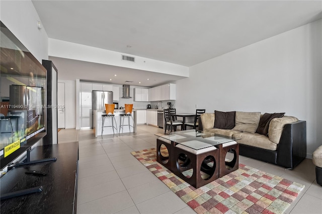 tiled living room featuring sink