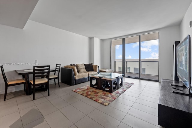 living room featuring expansive windows and light tile patterned flooring