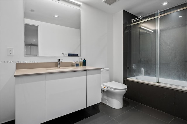 full bathroom with toilet, vanity, tile patterned floors, and enclosed tub / shower combo