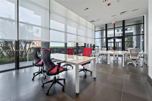 office space with a wall of windows and a towering ceiling