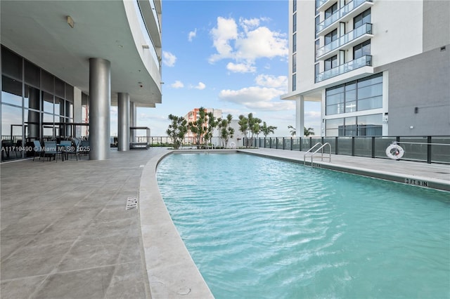 view of swimming pool with a patio area