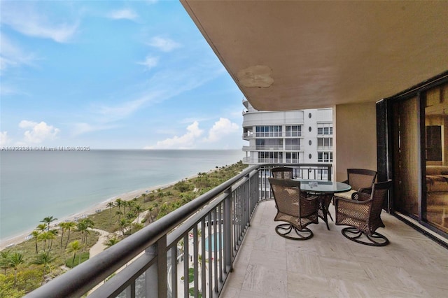 balcony with a beach view and a water view