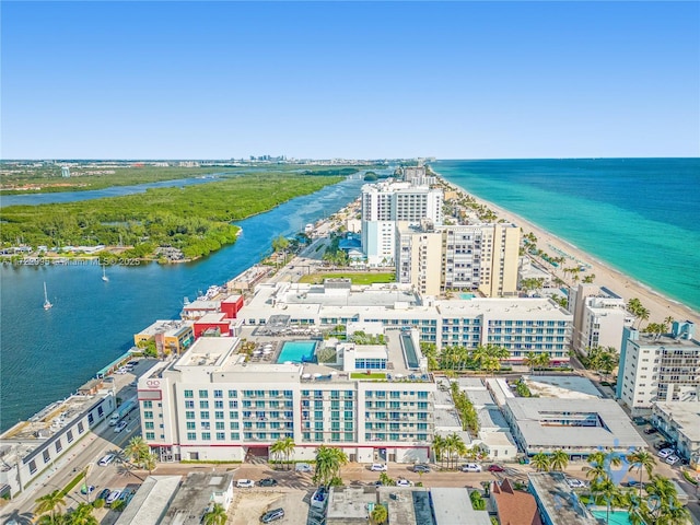 birds eye view of property featuring a beach view and a water view