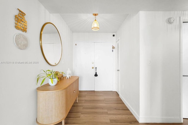 hallway with light hardwood / wood-style floors