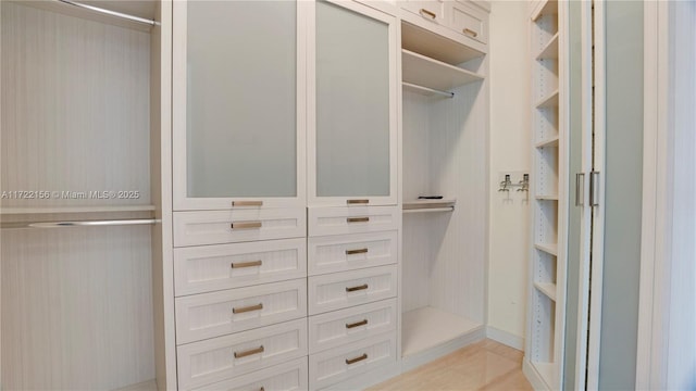 spacious closet with light tile patterned floors