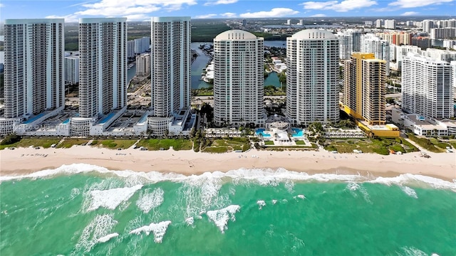 birds eye view of property with a water view and a view of the beach