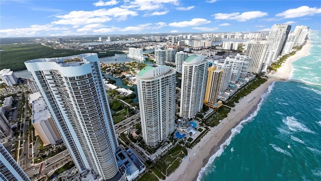 birds eye view of property featuring a water view and a beach view