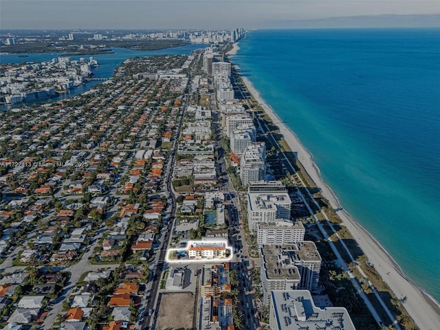 drone / aerial view featuring a beach view and a water view