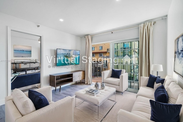 living room with a wealth of natural light and hardwood / wood-style flooring