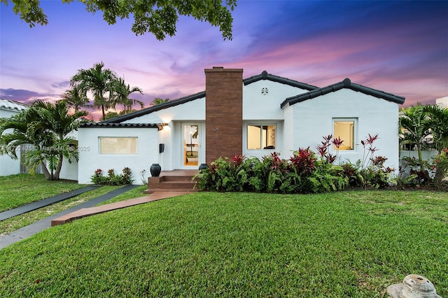 view of front of home with a lawn