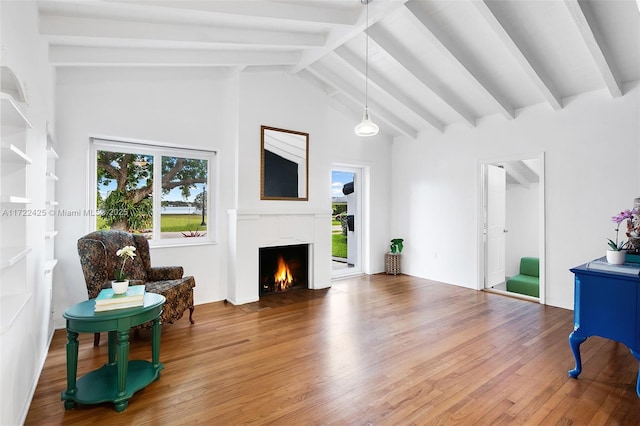 interior space with hardwood / wood-style floors, beam ceiling, and high vaulted ceiling