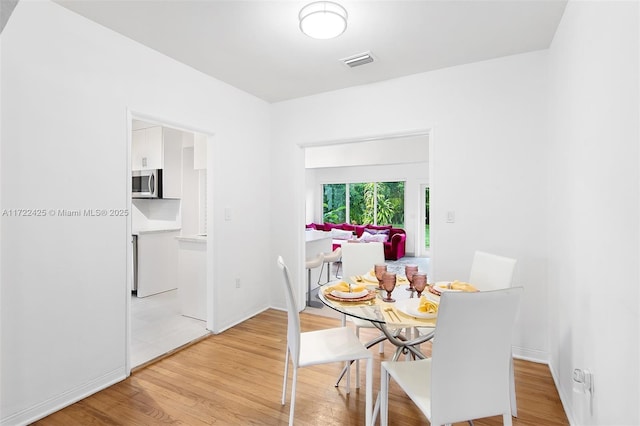 dining space with light hardwood / wood-style floors