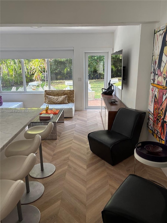 living room featuring a healthy amount of sunlight and light parquet flooring