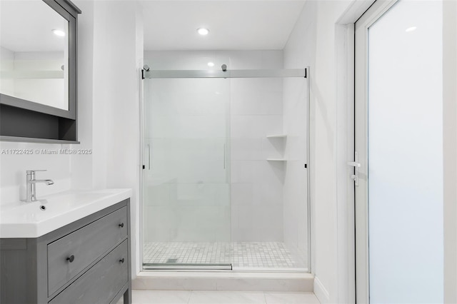 bathroom with vanity, tile patterned floors, and a shower with door